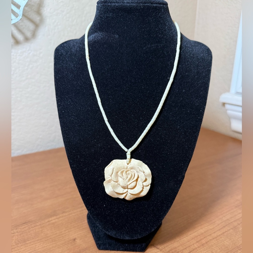 Antique carved bovine bone necklace with a rose pendant.